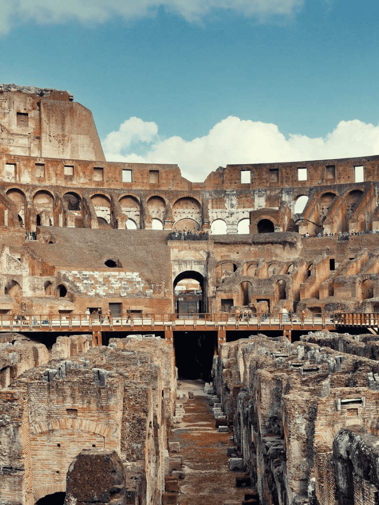 Ancient Roman Colosseum with historic ruins and stone arches, iconic landmark in Rome, Italy.