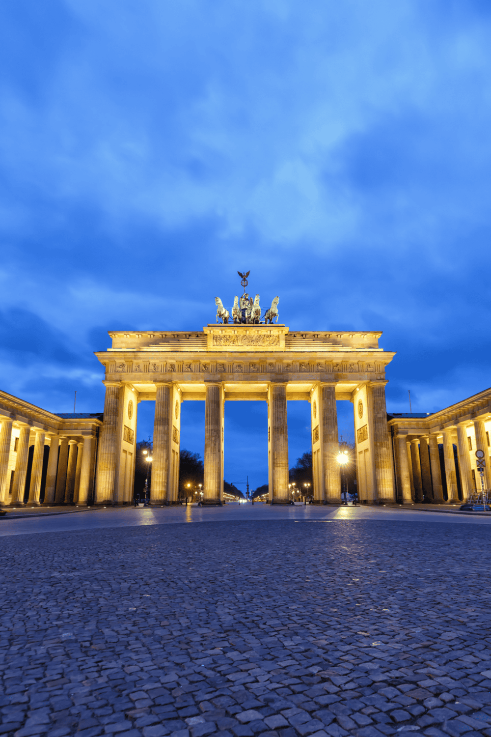 Historic Brandenburg Gate illuminated at night in Berlin, Germany| Iconic landmark and travel destination in Berlin| The Brandenburg Gate in Berlin, Germany, showcased at dusk, representing historic architecture and a top travel attraction.