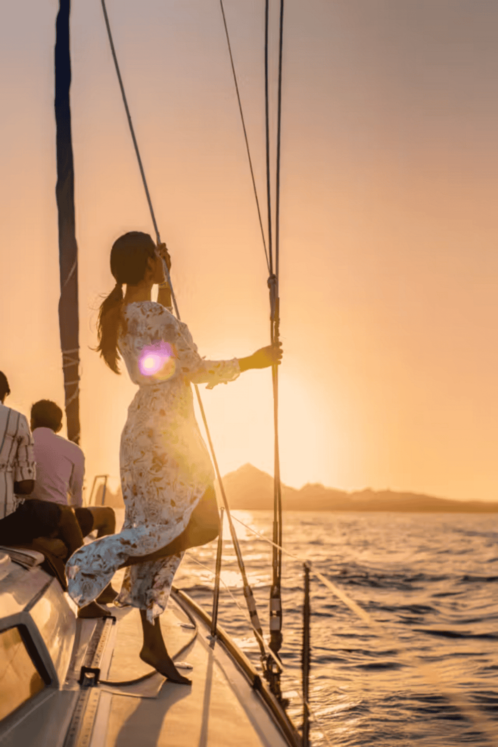 Sunset sailing with woman on boat, enjoying water adventure and navigation with QuestForDirections.