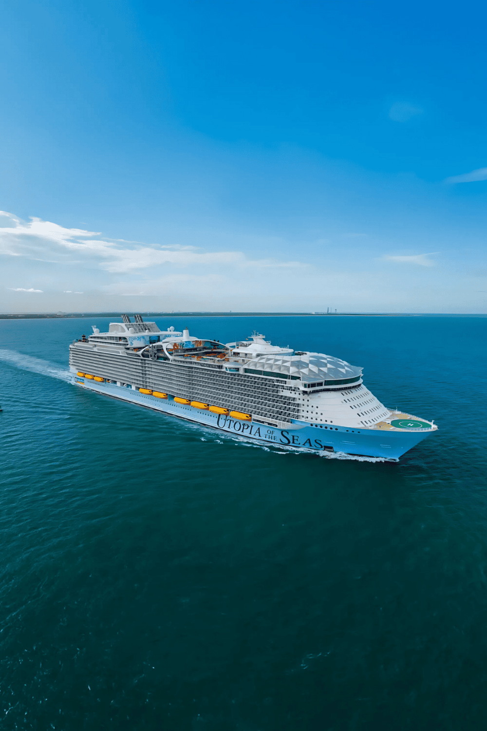 Luxurious cruise ship Utopia of the Seas sailing on clear blue ocean, offering unforgettable sea adventure.