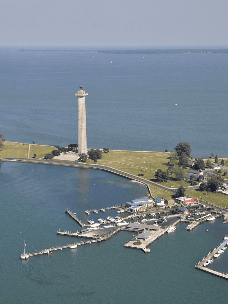 Lighthouse overlooking the water and marina with boats at Quest for Directions.