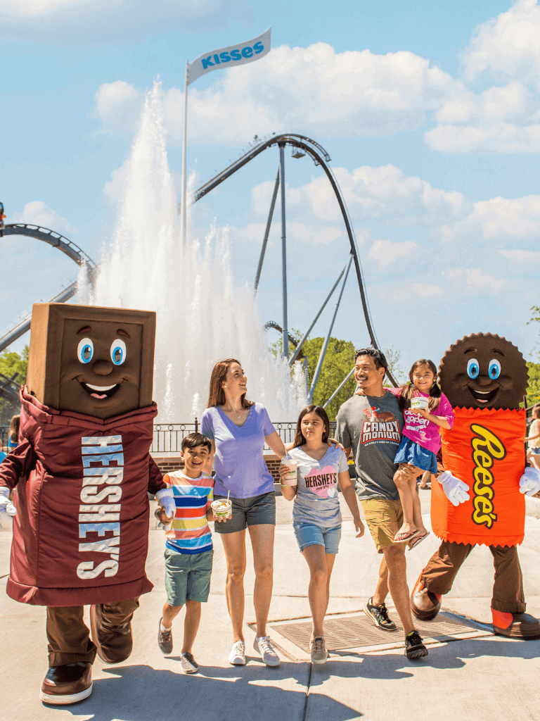 1. Family enjoying fun at Hersheypark amusement park with water rides and Hershey's mascot characters.