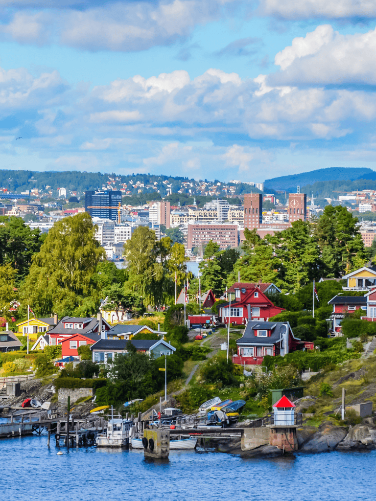 Charming waterfront neighborhood with colorful houses and city skyline view, showcasing QuestForDirections SEO focus.
