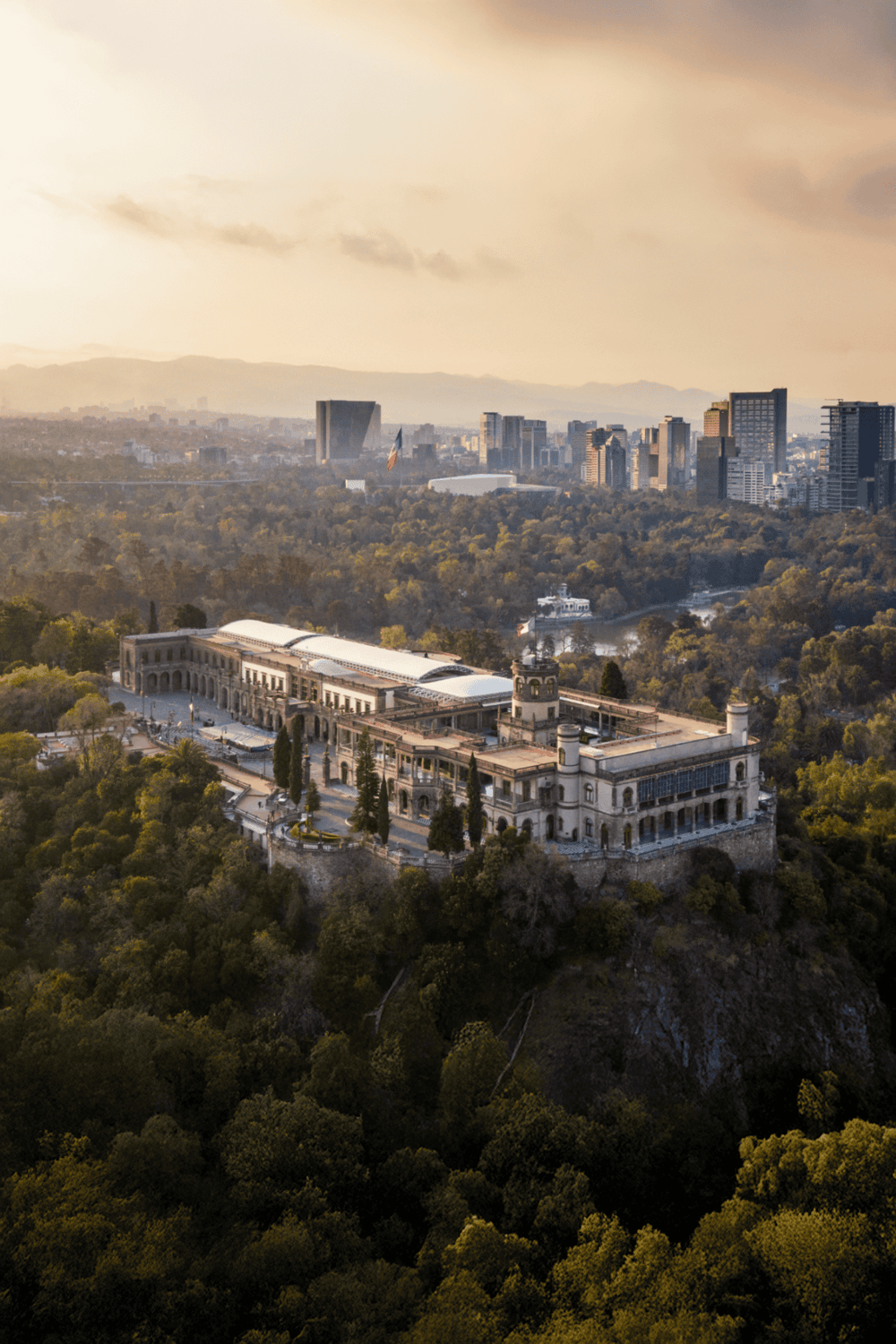Majestic historic mansion overlooking Los Angeles skyline with lush greenery, focusing on city sightseeing and scenic views.
