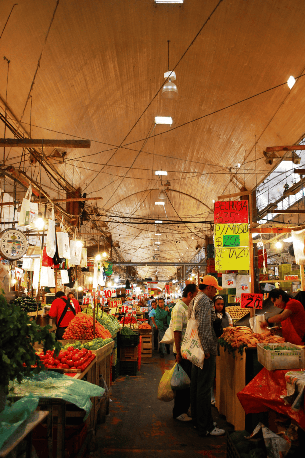 Colorful indoor market with fresh produce and vibrant signage for groceries.