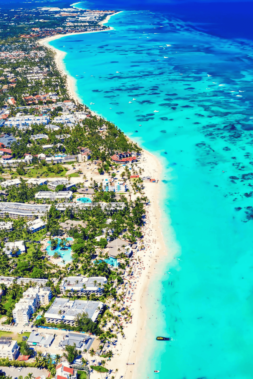 Bright Caribbean beach resort with turquoise waters, white sand, and vibrant palm trees, perfect for vacation planning.