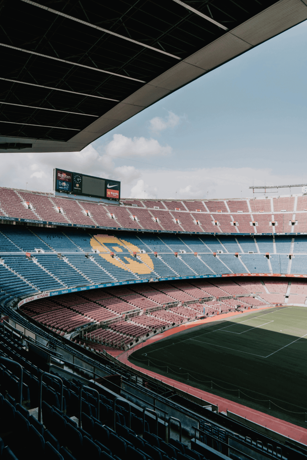 Upskirt shot of stadium seats with view of the pitch at Camp Nou for a sporting event.