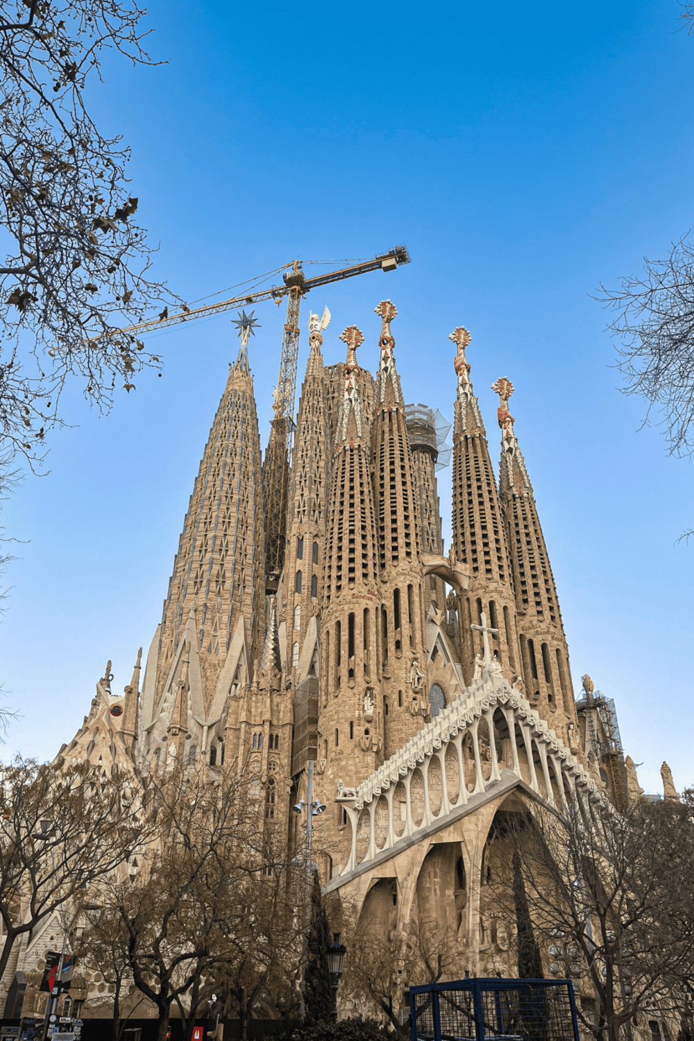 Iconic Sagrada Família basilica in Barcelona under blue sky, architectural masterpiece by Antoni Gaudí.
