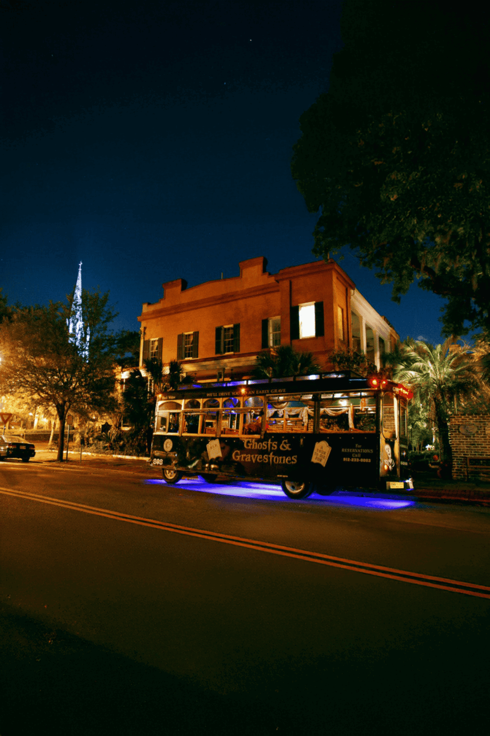 Haunted trolley car decorated for Ghosts & Gravesites tour at night.