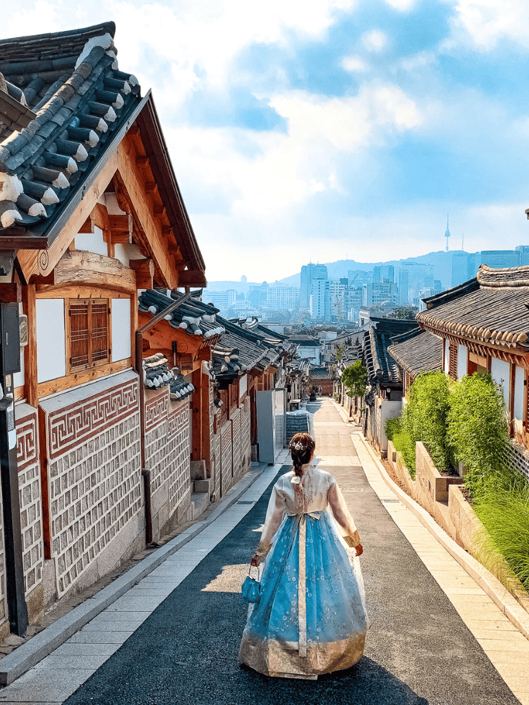 Historic Korean hanok village with traditional architecture and scenic city view in Seoul.