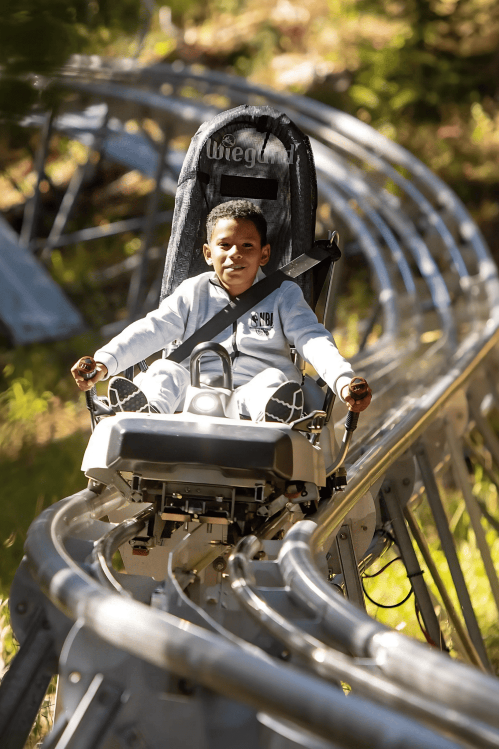 Kids amusement park ride, roller coaster for children at outdoor amusement park, happy child adventure fun, family entertainment attraction, QuestForDirections.