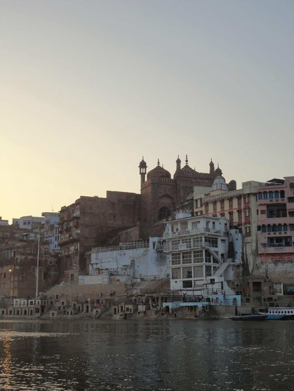 Ancient fort and colorful buildings along the river in Varanasi, India.