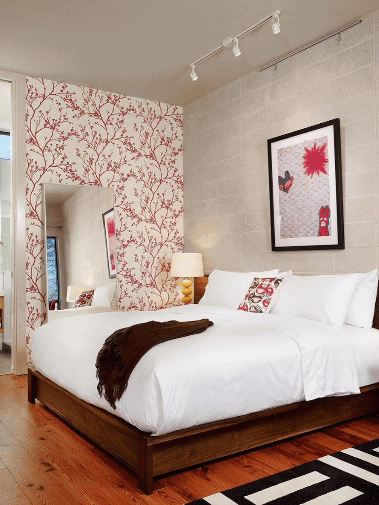 Stylish bedroom with floral accent wall, cozy bedding, and modern decor for home comfort and interior design.