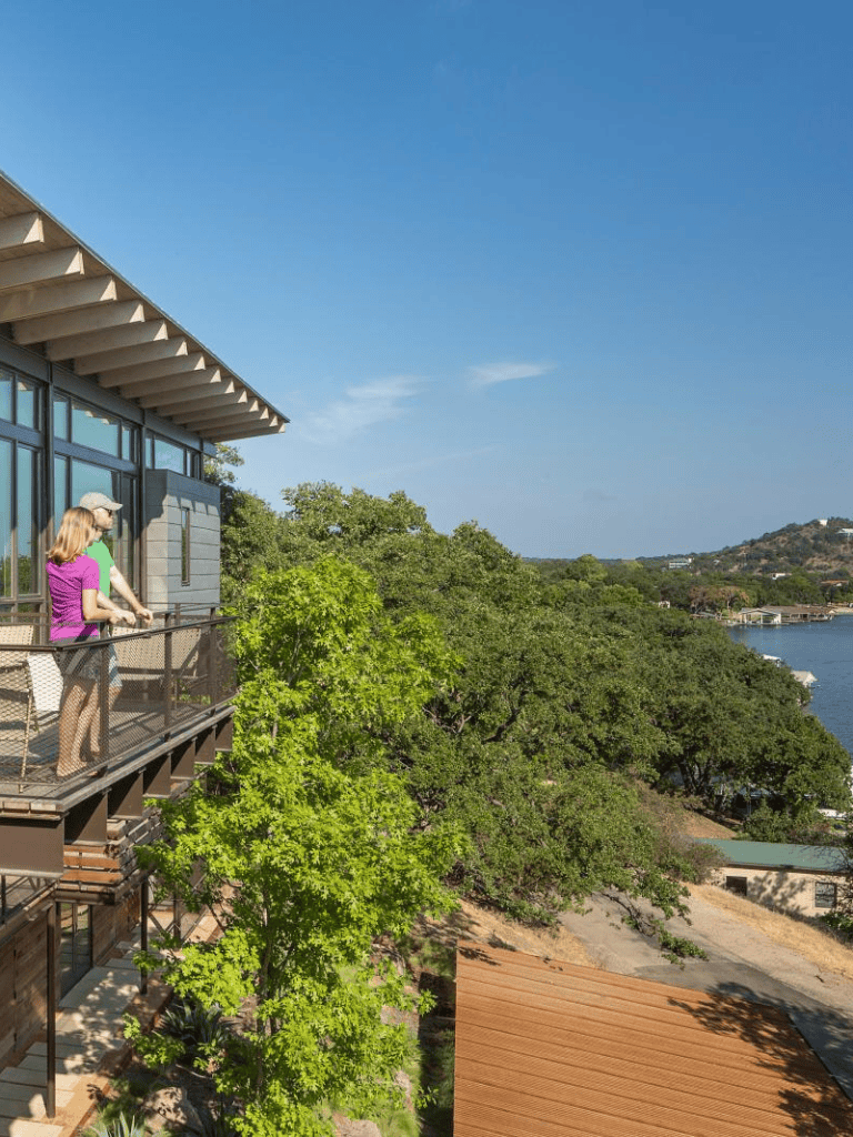Stunning view from a balcony overlooking trees and water at QuestForDirections.