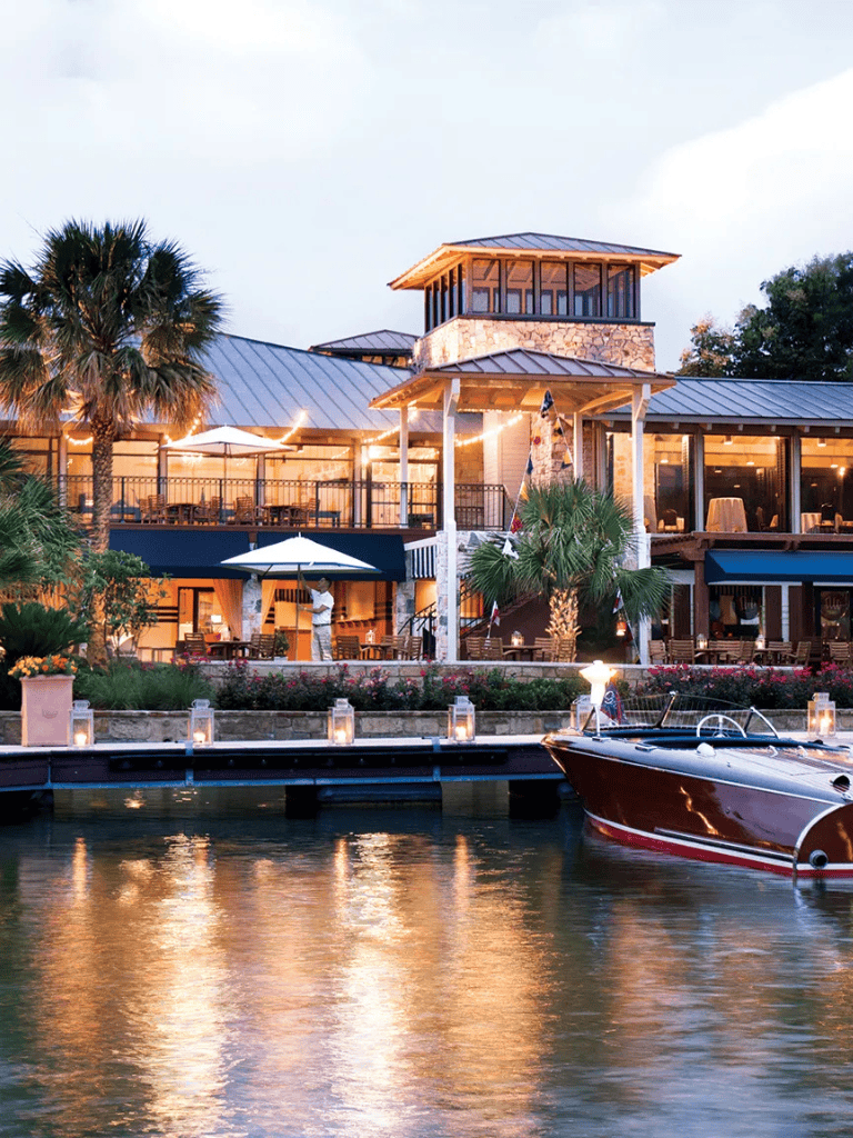 Luxurious waterfront restaurant with outdoor dining and boat access at QuestForDirections.