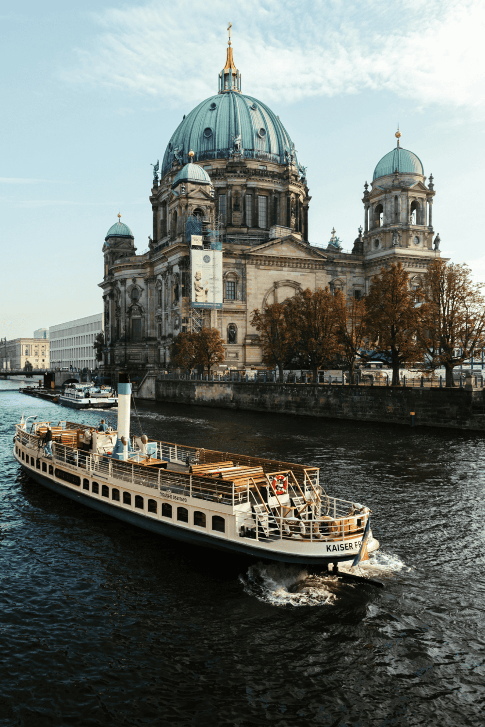 Berlin Cathedral and River Spree, Germany, with boat cruise and historic architecture in city center.