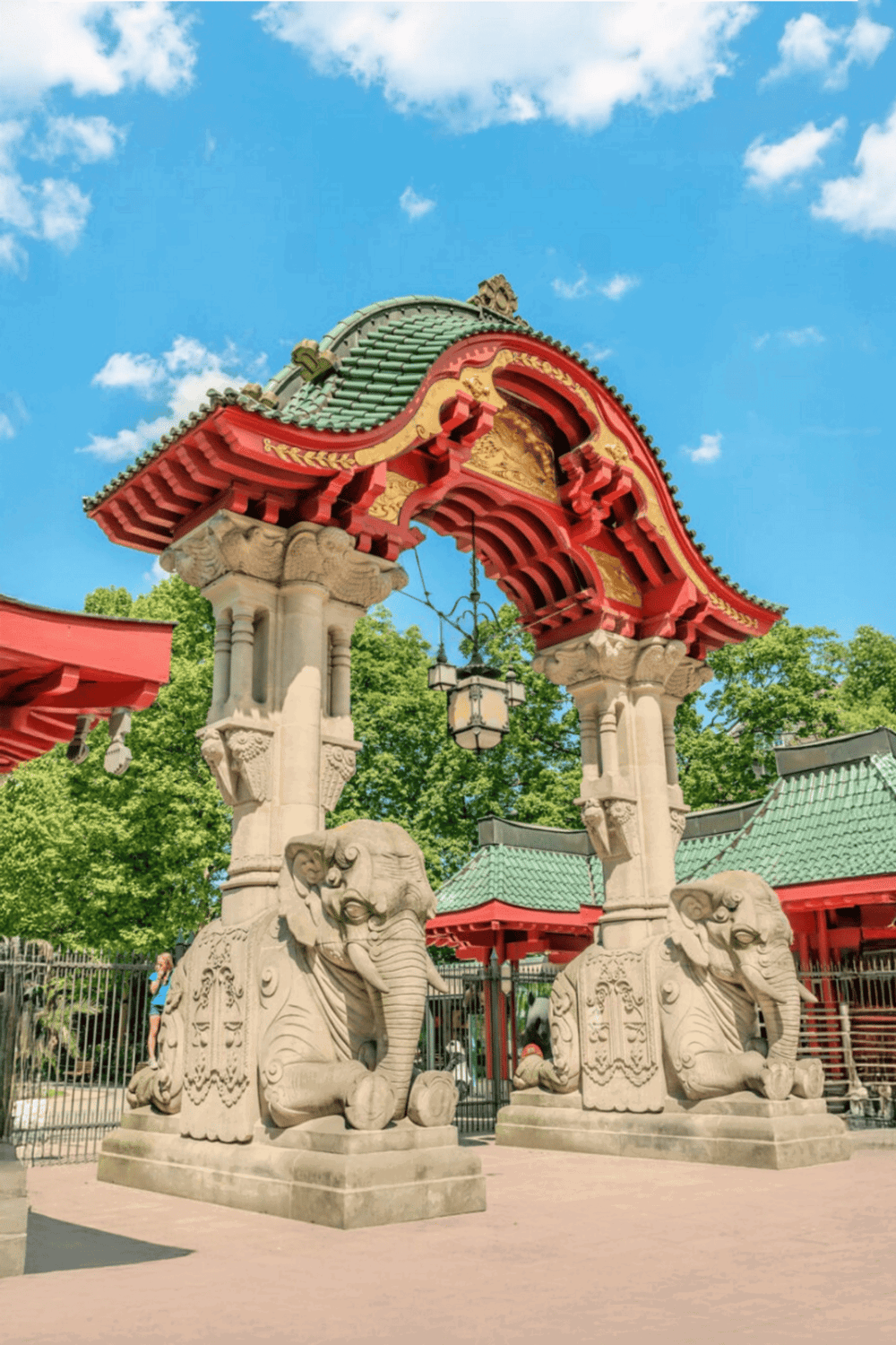 Colorful Asian-style park entrance with traditional architecture and stone elephant statues.