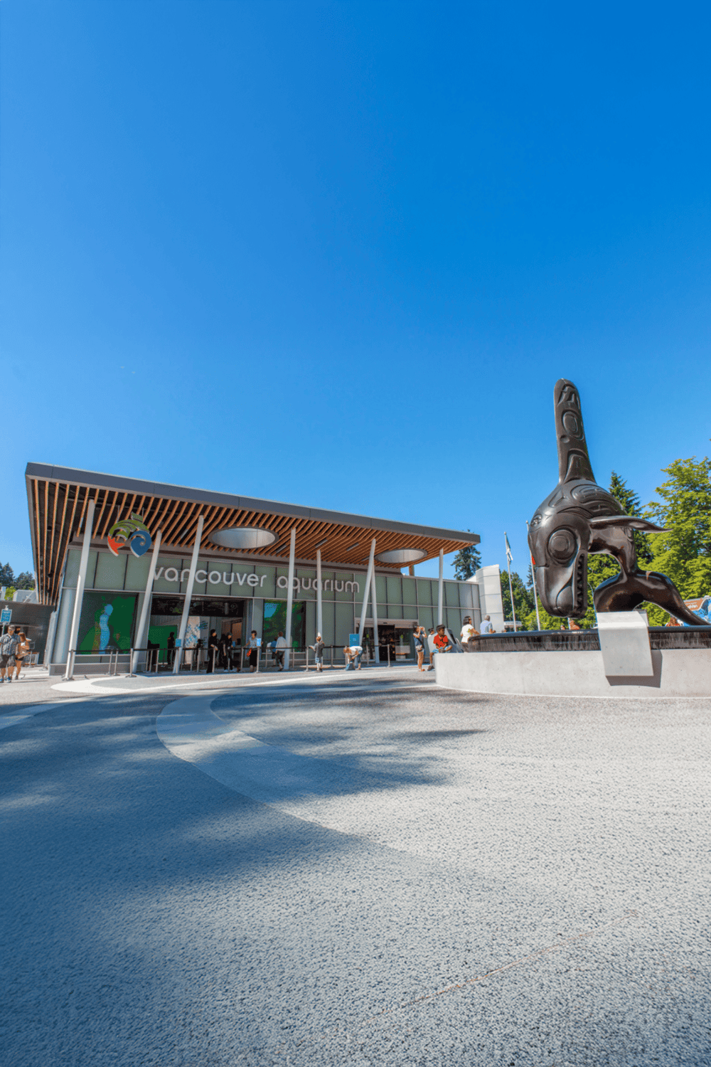 Vancouver Aquarium entrance with modern architecture and iconic animal sculpture on a sunny day.