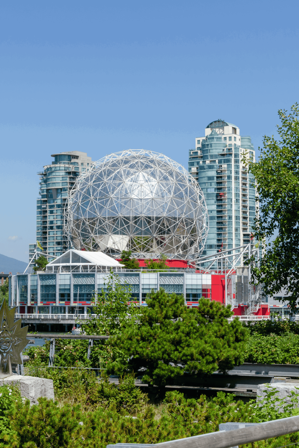 Golden Gate Park Geodesic Dome, San Francisco skyline with modern buildings and lush greenery.