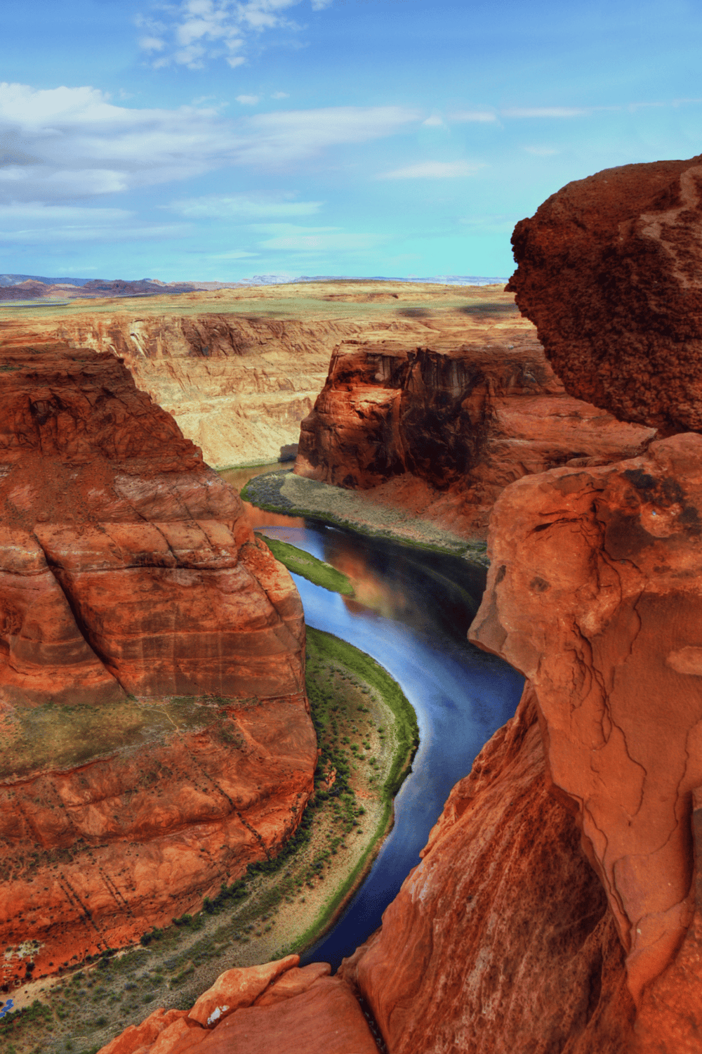 Vivid image of the Grand Canyon river canyon, showcasing stunning red rock formations and a winding river.