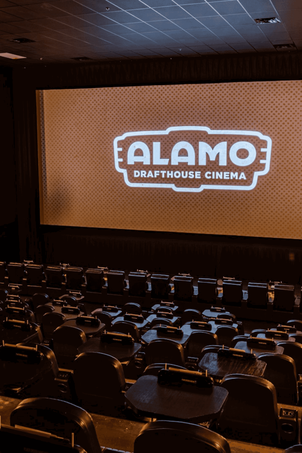 1. Alamo Drafthouse Cinema interior with large projection screen and cozy seating.