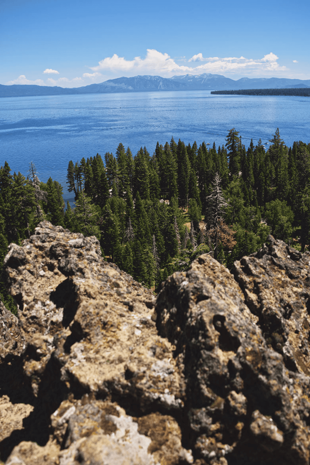 Aerial view of lakes, mountains, and pine forests, showcasing natural scenic beauty and outdoor exploration.