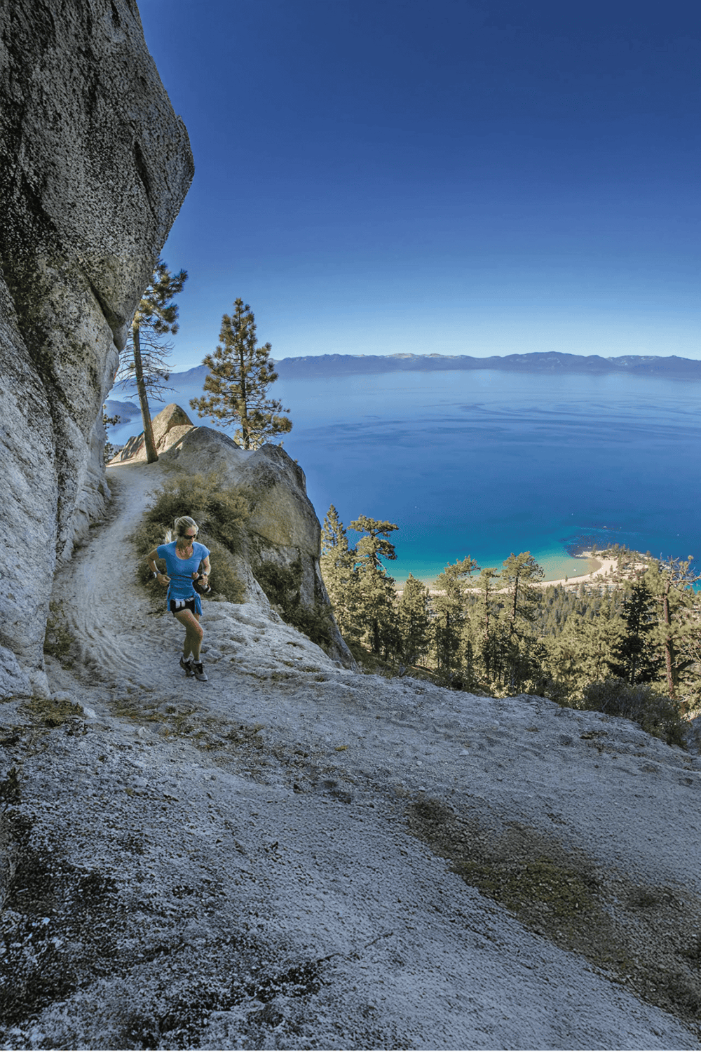 Scenic trail running along a mountain with lake and forest view, outdoor adventure, fitness, wellness, nature exploration.