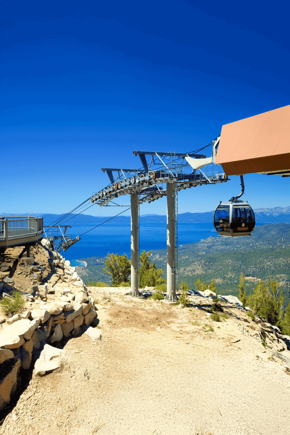 Cable car ride over mountainous landscape with lake views.