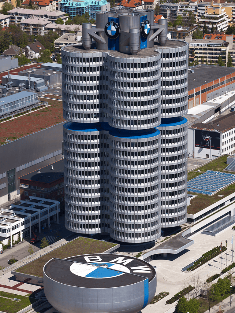 BMW headquarters building in Munich, Germany with BMW logos on the rooftop.