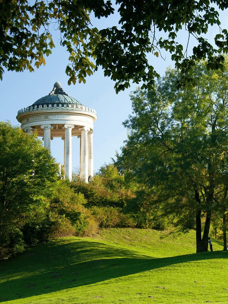 Serene park with historic gazebo and lush green trees, perfect for relaxation and outdoor exploration.
