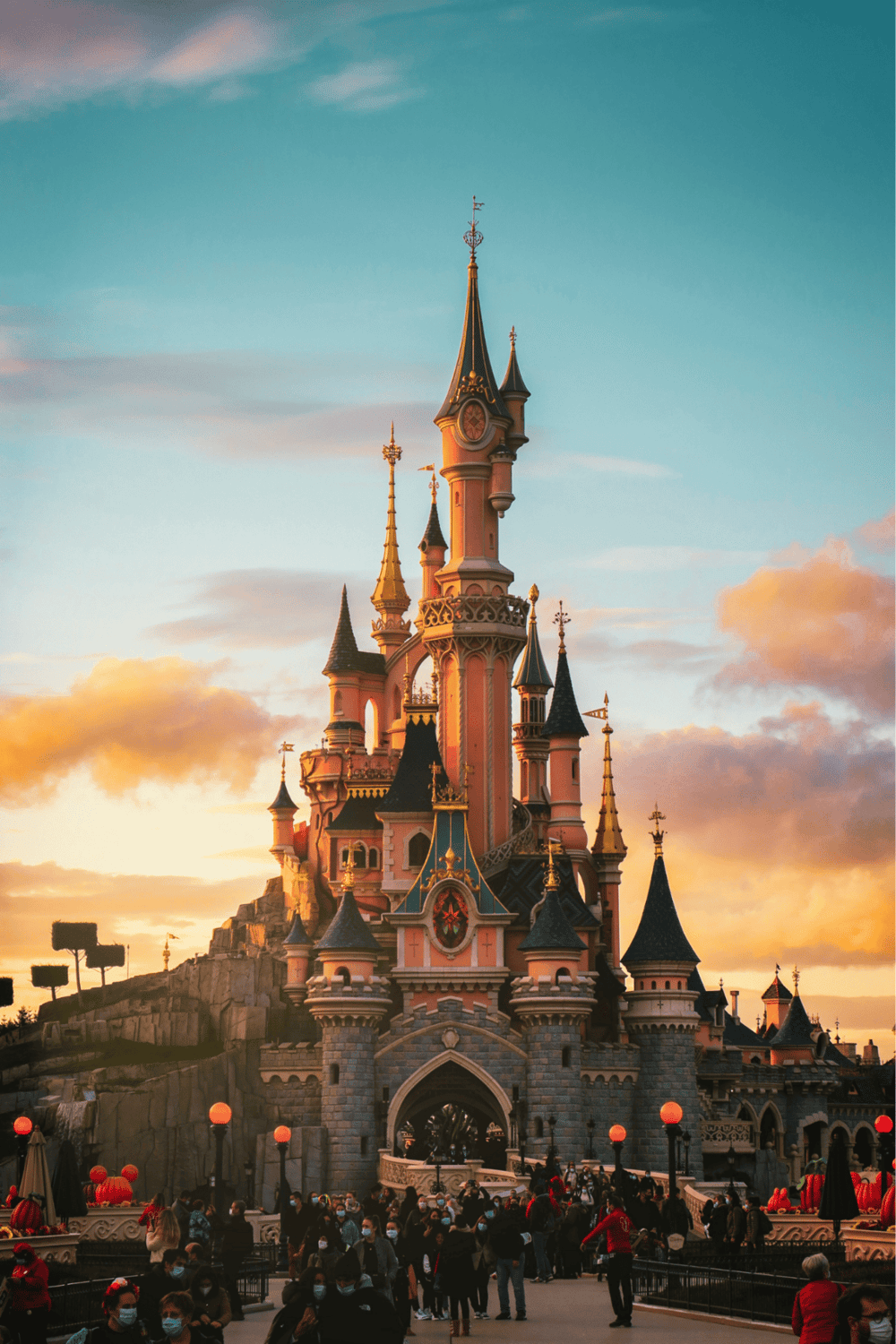 Enchanted Disney castle at sunset, iconic Disney theme park destination, popular tourist attraction, family-friendly entertainment.