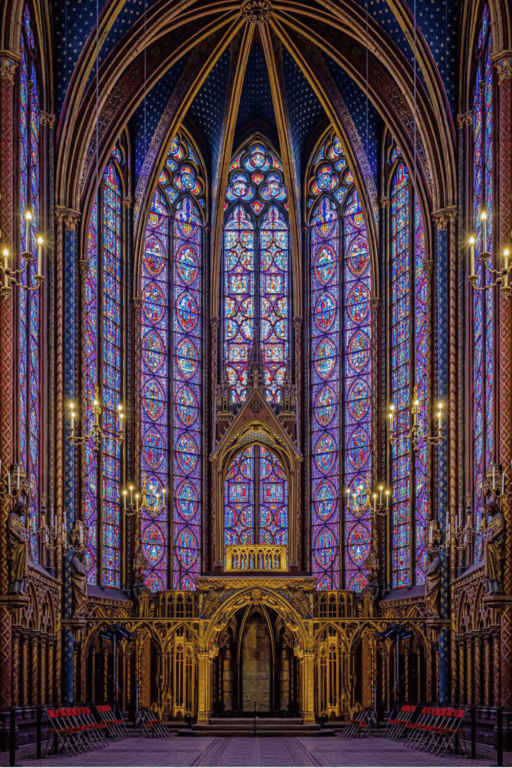 Stunning stained glass windows inside a Gothic cathedral, showcasing vibrant colors and intricate design.