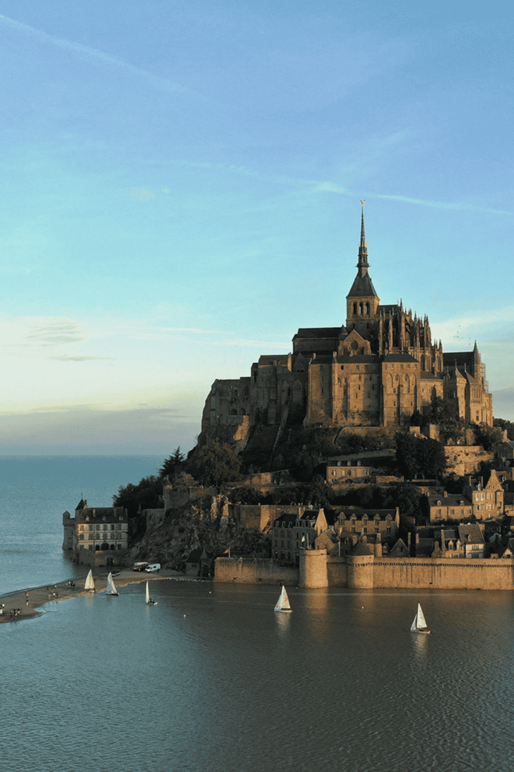 Ancient castle on a hill overlooking a river with sailboats, Paris landmark, travel destination, architecture, tourism site.