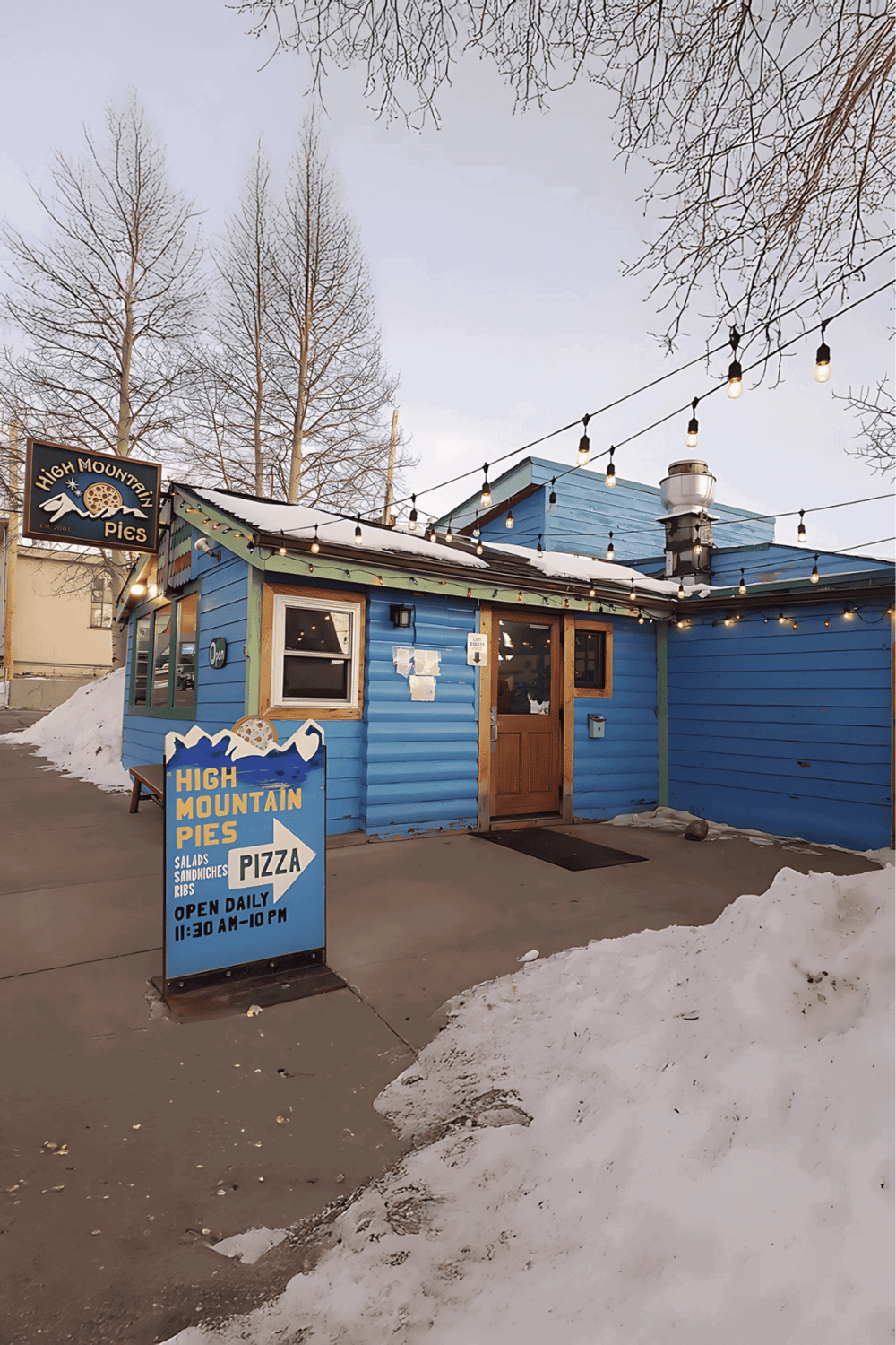 Fresh mountain-inspired pies and meals at High Mountain Pies in a cozy, snow-covered mountain town setting.