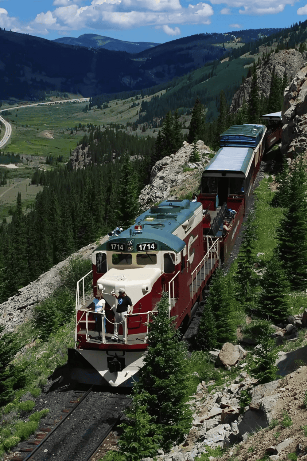 Vintage train traveling through scenic mountain landscape for adventure travel enthusiasts.