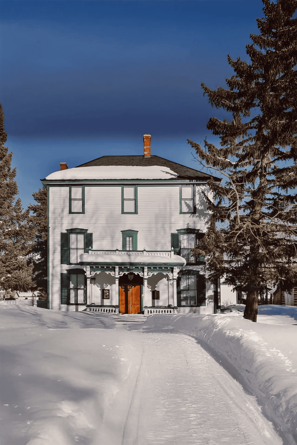 Cozy historic house covered in snow in a winter landscape, ideal for travel and sightseeing in snowy destinations.