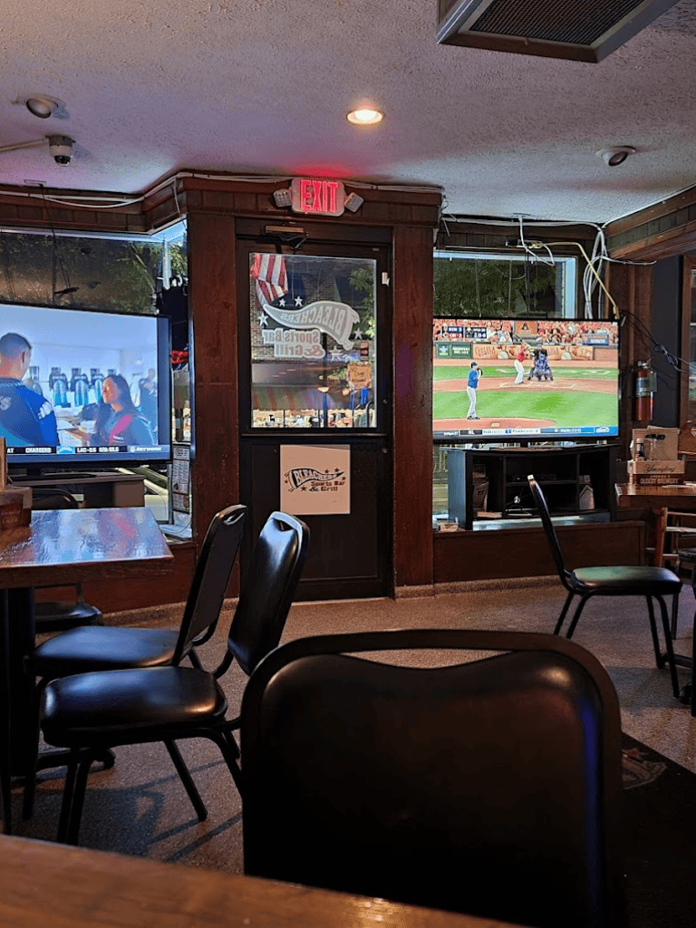 Cozy sports bar with multiple TVs showcasing baseball games, perfect for sports fans and social gatherings.