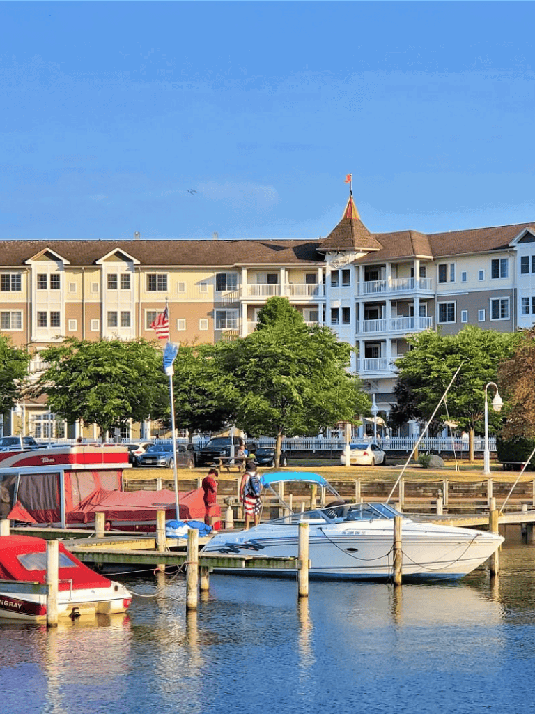 Relaxing waterfront scene with boats and a resort-style building, perfect for vacation planning and navigation assistance.