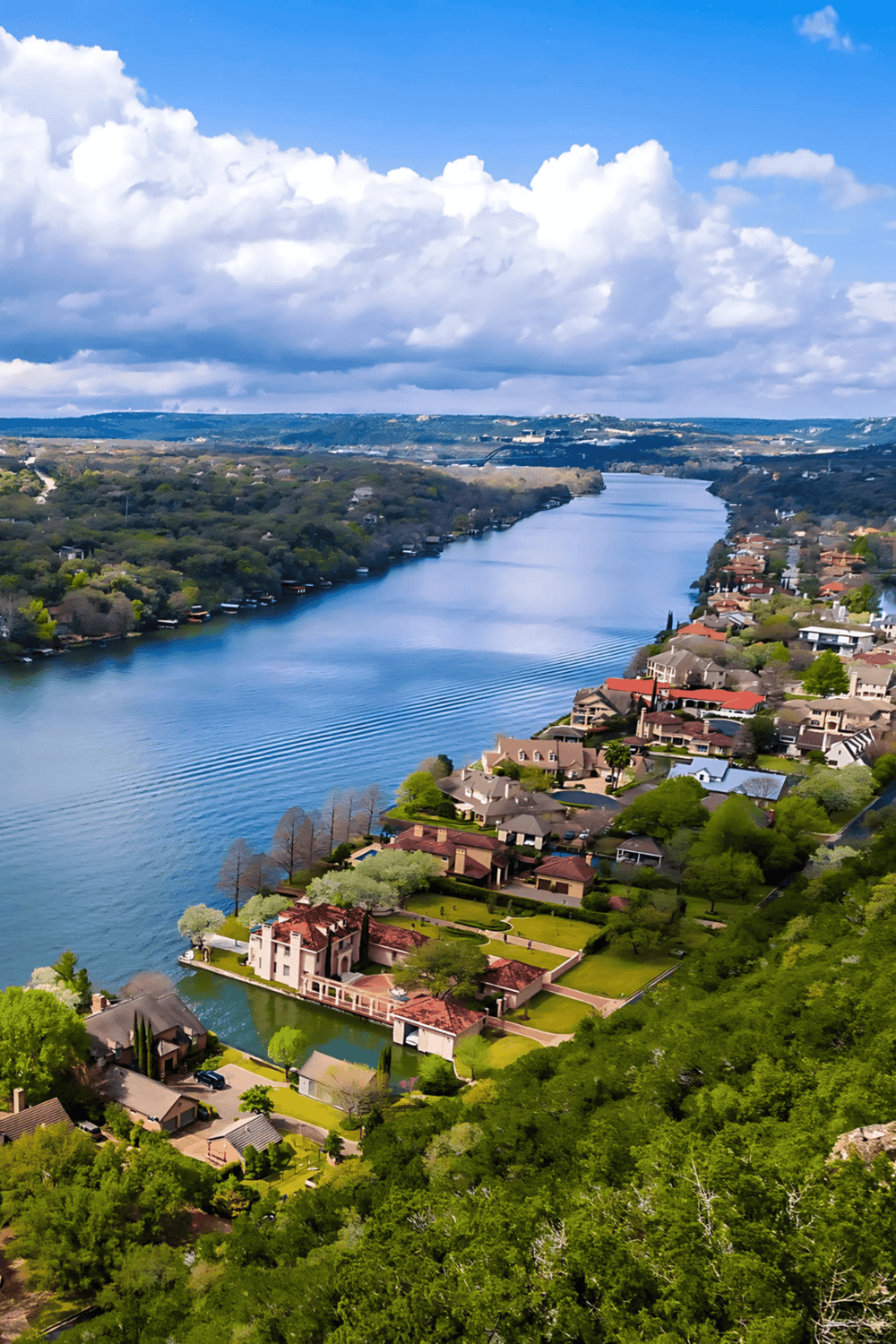 Serene river view with residential homes and lush greenery, showcasing scenic outdoor landscapes for travel inspiration.
