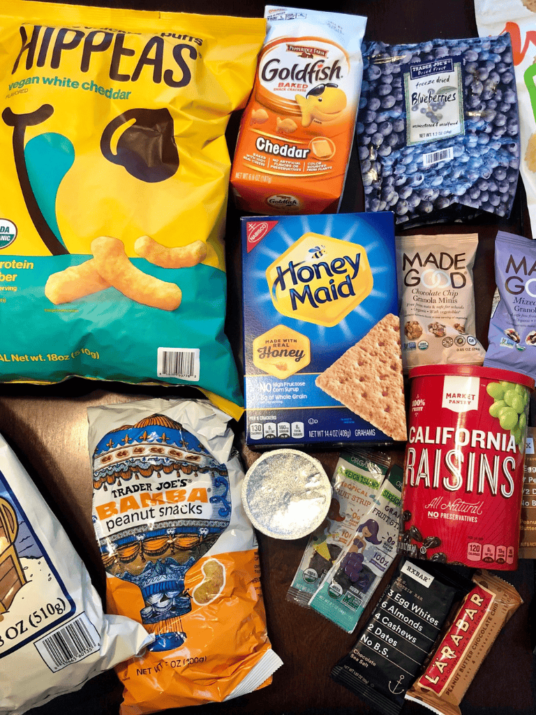 Snacks and healthy foods including chips, blueberries, and granola for on-the-go nutrition.