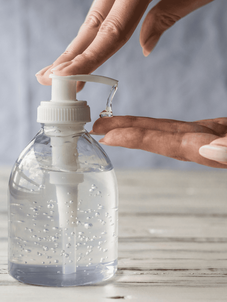 1. Hand pressing sanitizer on hands for hygiene and safety.