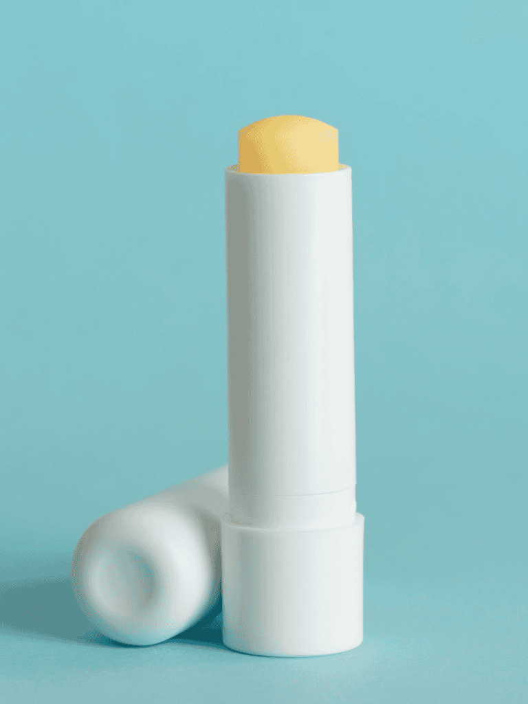 Lip balm stick for moisturizing and protecting dry lips, compact and portable.
