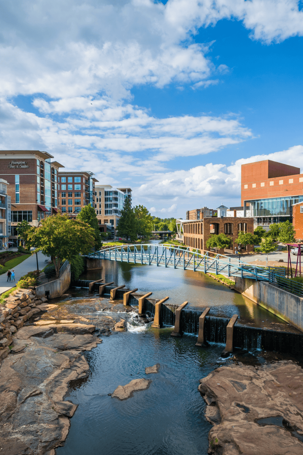 Vibrant cityscape with modern buildings and a scenic river, perfect for urban exploration and lifestyle.