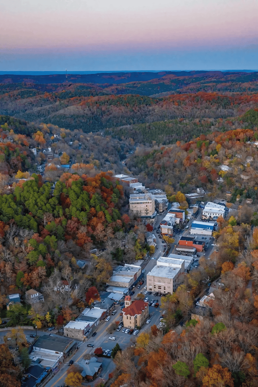 Downtown town nestled in fall foliage, scenic mountains, vibrant community, QuestForDirections travel guide.