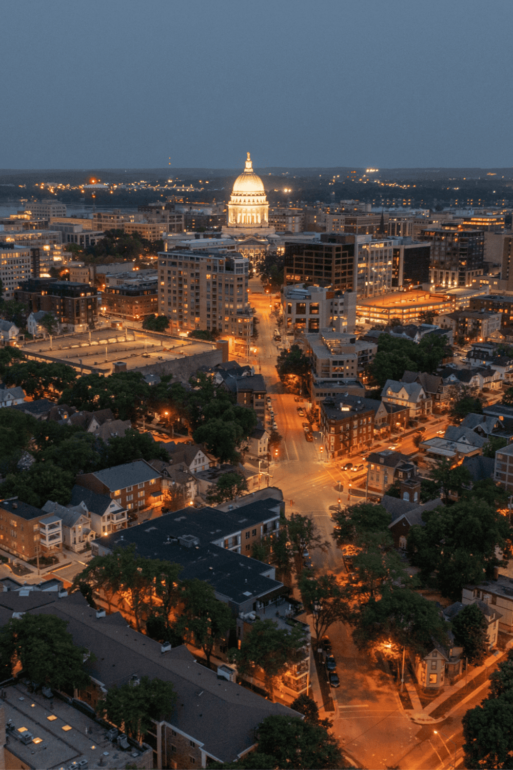 Downtown Atlanta cityscape at night spotlighting the Georgia State Capitol building.