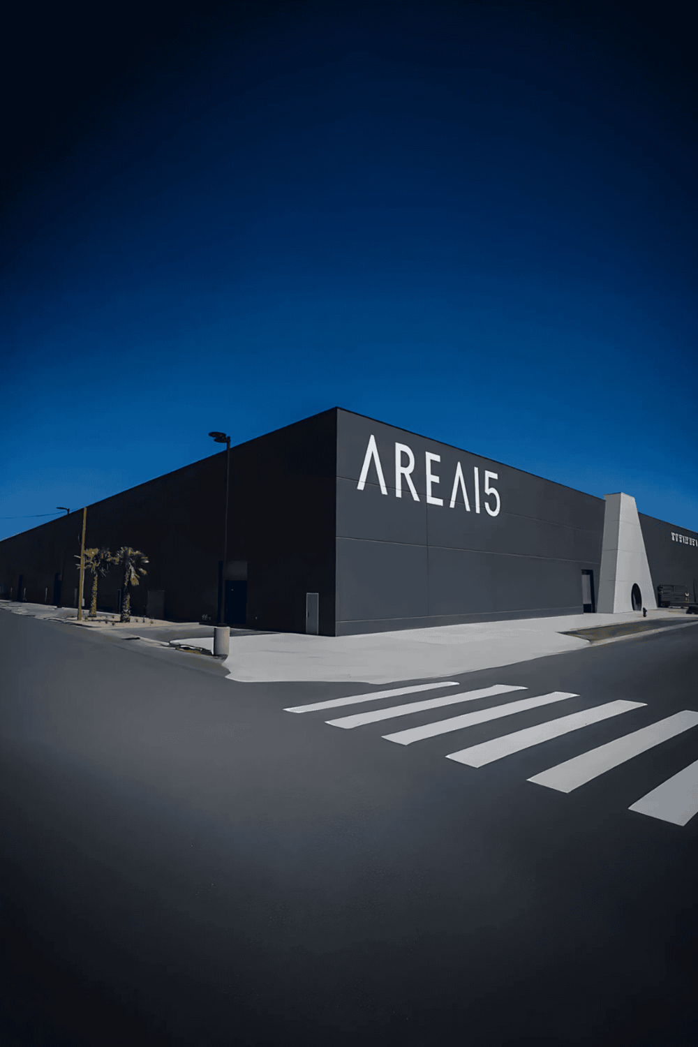 Ultra-modern arena exterior with bold signage, illuminated at dusk, showcasing entertainment venue innovation.