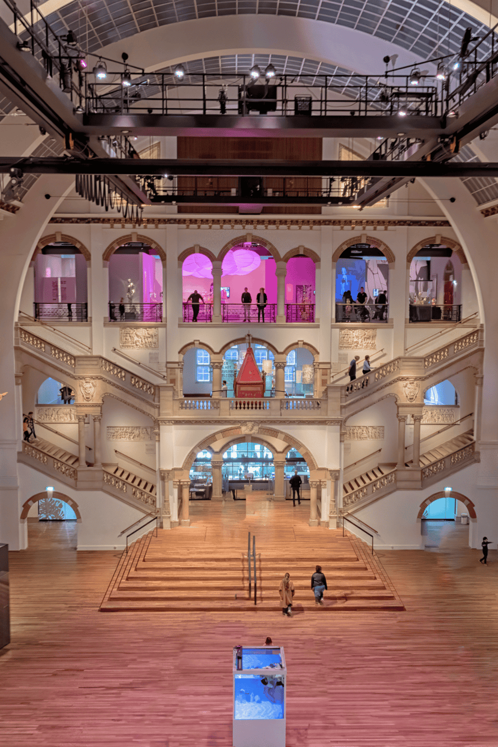 Elegant historic building interior with grand staircase and modern exhibits, showcasing art and culture.