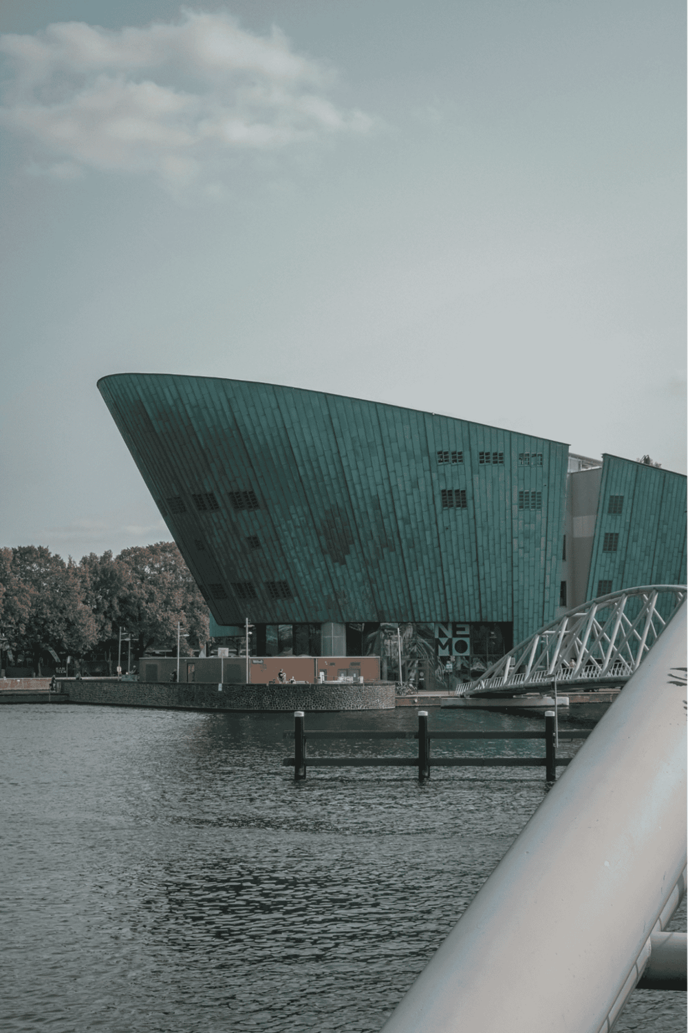 Modern city museum building with waterfront view, innovative architecture in an urban environment.