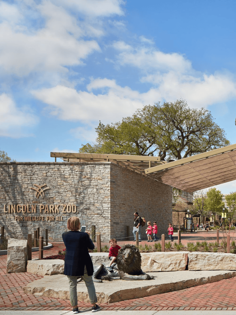 Lincoln Park Zoo entrance with children and families visiting, outdoor setting, urban park, popular family attraction, wildlife conservation, Chicago Illinois.