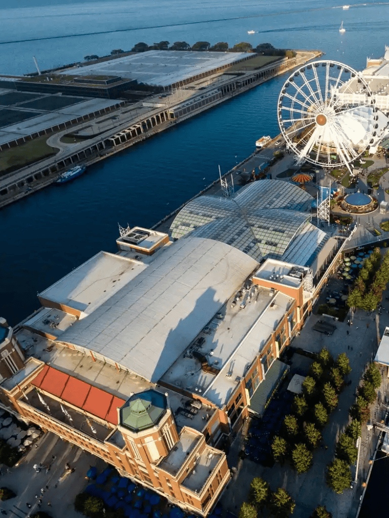 Aerial view of QuestForDirections waterfront entertainment and shopping complex with ferris wheel.